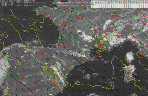 Fig.2: Surface observation with 300 hPa wind barbs atop. Background is a visible image. @ 1645 MESZ